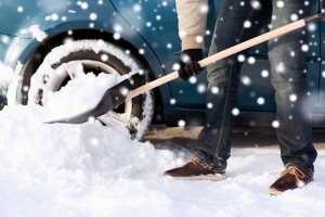Man shovels snow from his driveway.