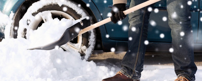Man shovels snow from his driveway.