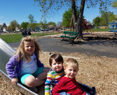 Kids playing on a slide.